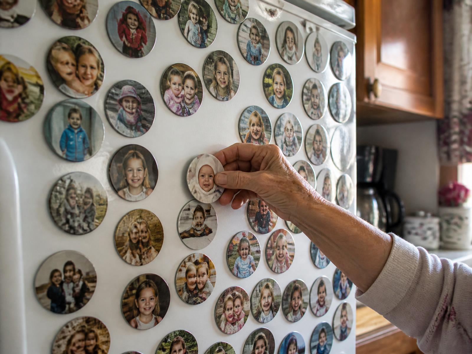 Personalized photo magnets of grandchildren on a grandmother's refrigerator